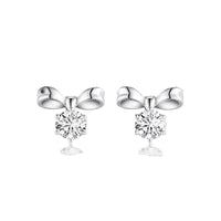Silver bow-shaped earrings with clear gemstones on a white background
