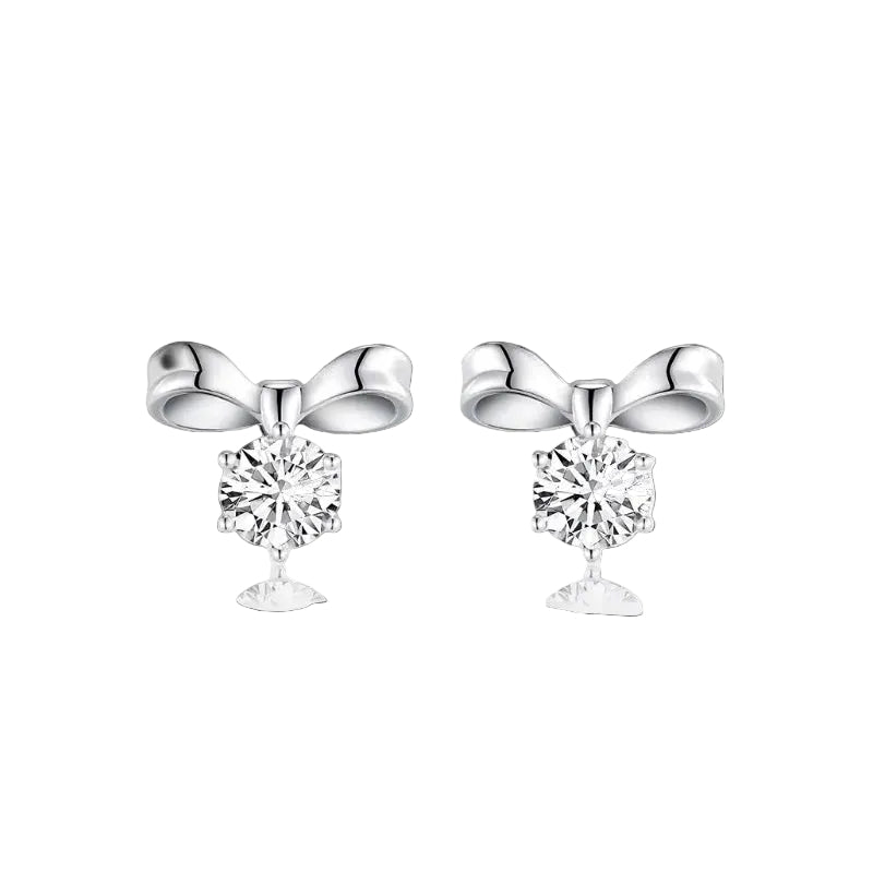 Silver bow-shaped earrings with clear gemstones on a white background
